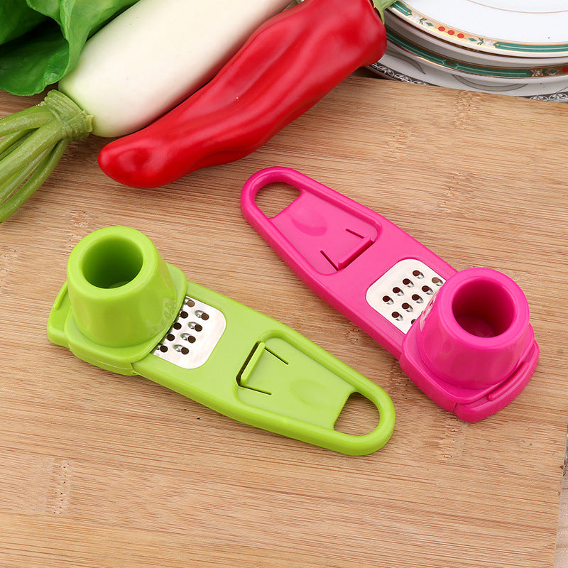 Action Shot: Hands twisting the AeroTwist handheld kitchen gadget to crush fresh garlic and ginger pieces.