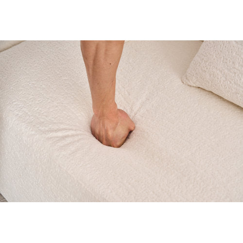 Coordinated set of 4 matching chenille throw pillows resting on the deep 3-seater couch.
