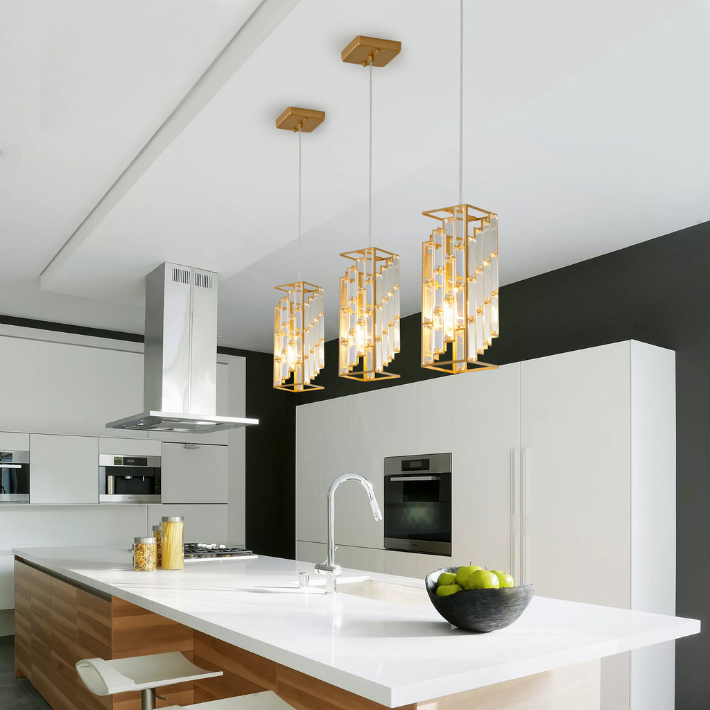 Three-pack adjustable hanging ceiling lamp setup suspended seamlessly in a linear row over a sleek modern counter.