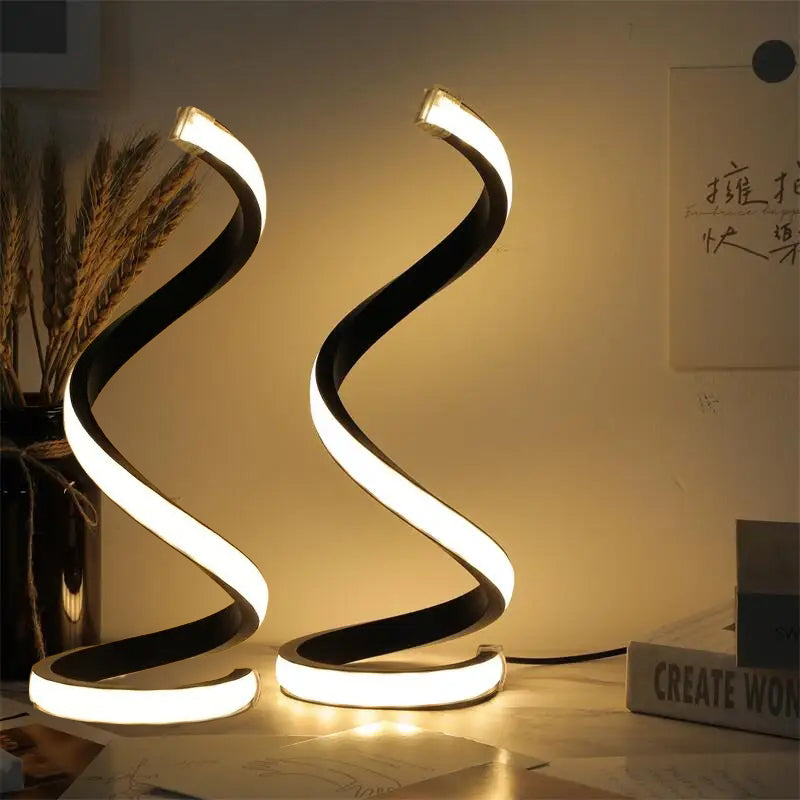 Close-up of the s-curve design and trendy brushed metal finish on the minimalist table lamp.