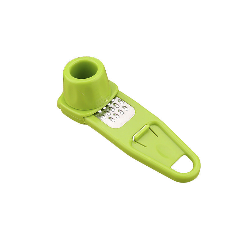 Main Product Image: AeroTwist manual garlic masher and grinder holding fresh minced cloves inside the chamber.