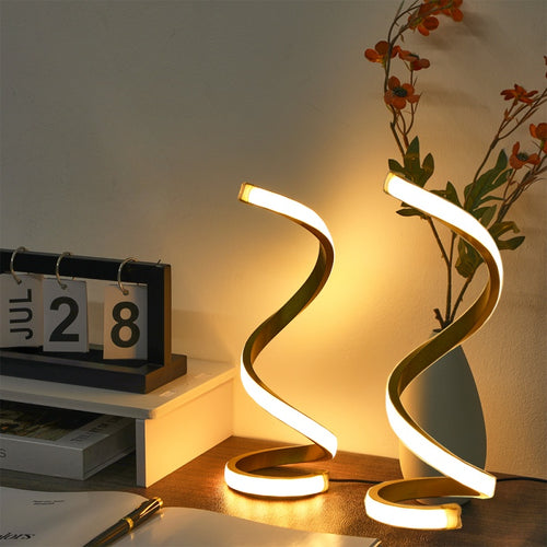 AeroHelix 2 piece spiral LED desk lamp set glowing with warm white light on twin bedroom nightstands.