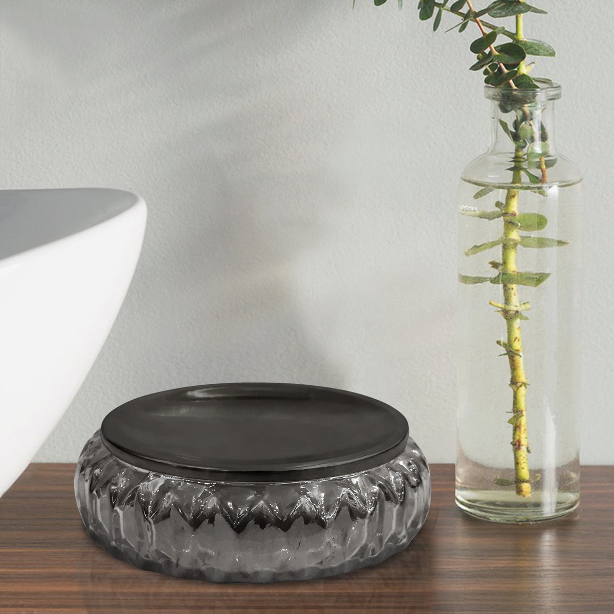 Thickened smoke grey glass soap tray showcasing light transparency on a marble vanity